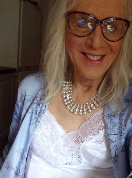 Wearing gown and white satin & lace lingerie.