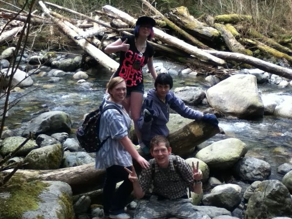 Us sitting on a log by the river