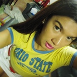 in yellow baby tee and denim mini-skirt